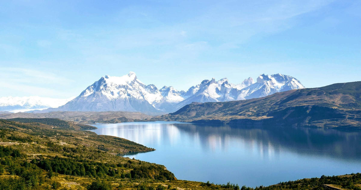 Snow-capped Patagonian peaks reflected in a glacial lake in South America, ideal for an overland eSIM trip