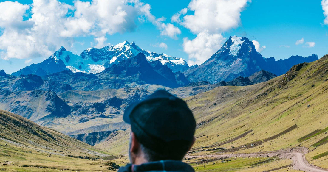 Traveller from behind looking out at snowy Peruvian Andes — a brand-neutral Latin America connectivity image for comparing eSIM providers.