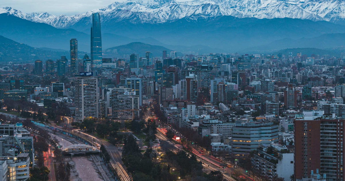 Santiago skyline at dusk with the snow-capped Andes mountains behind it, Chile