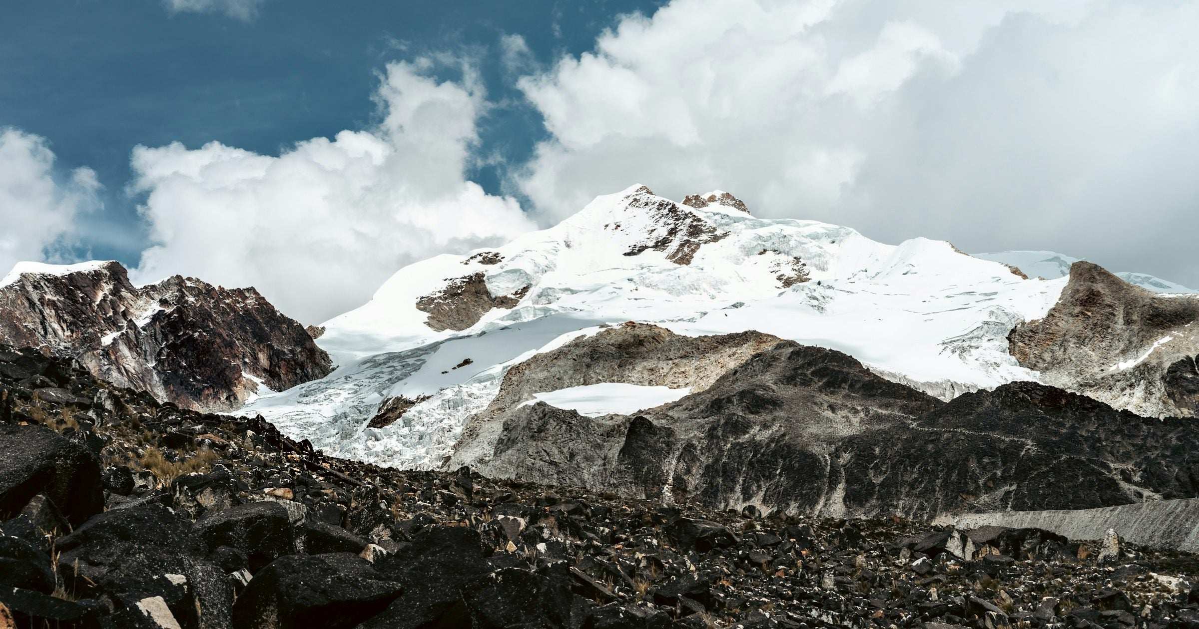 Snow-capped Andean peaks rising above a rocky highland — Latin American mountain landscape