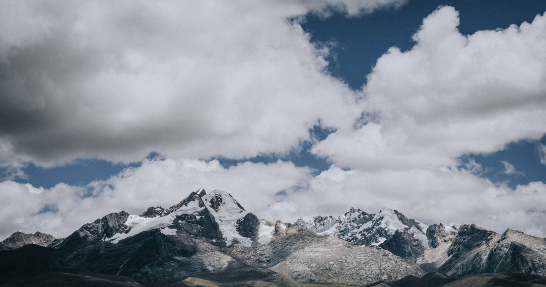 Sweeping snow-capped Andean range stretching across a wide Latin American landscape
