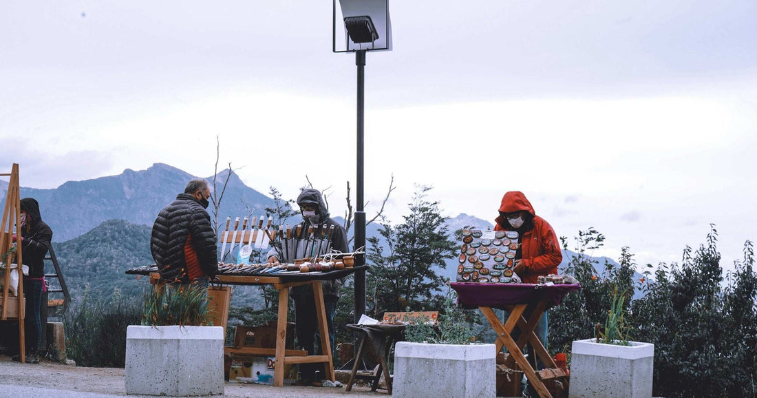 Local market stalls beneath the Patagonian Andes — slow-travel and cost-of-living guide to Bariloche, El Chaltén and Puerto Natales for long-stay travellers in 2026.