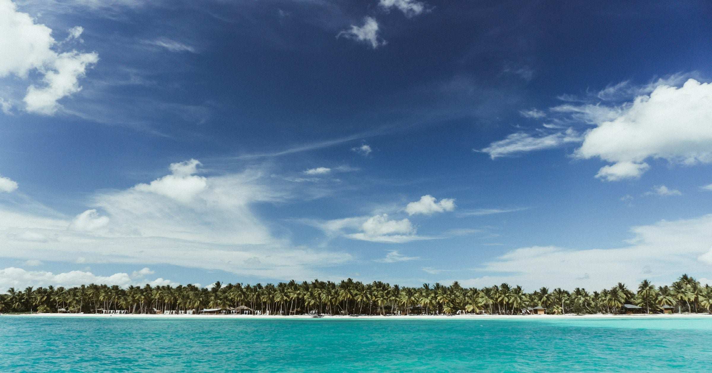 Caribbean island palms across turquoise water — eSIM data plans for island travel