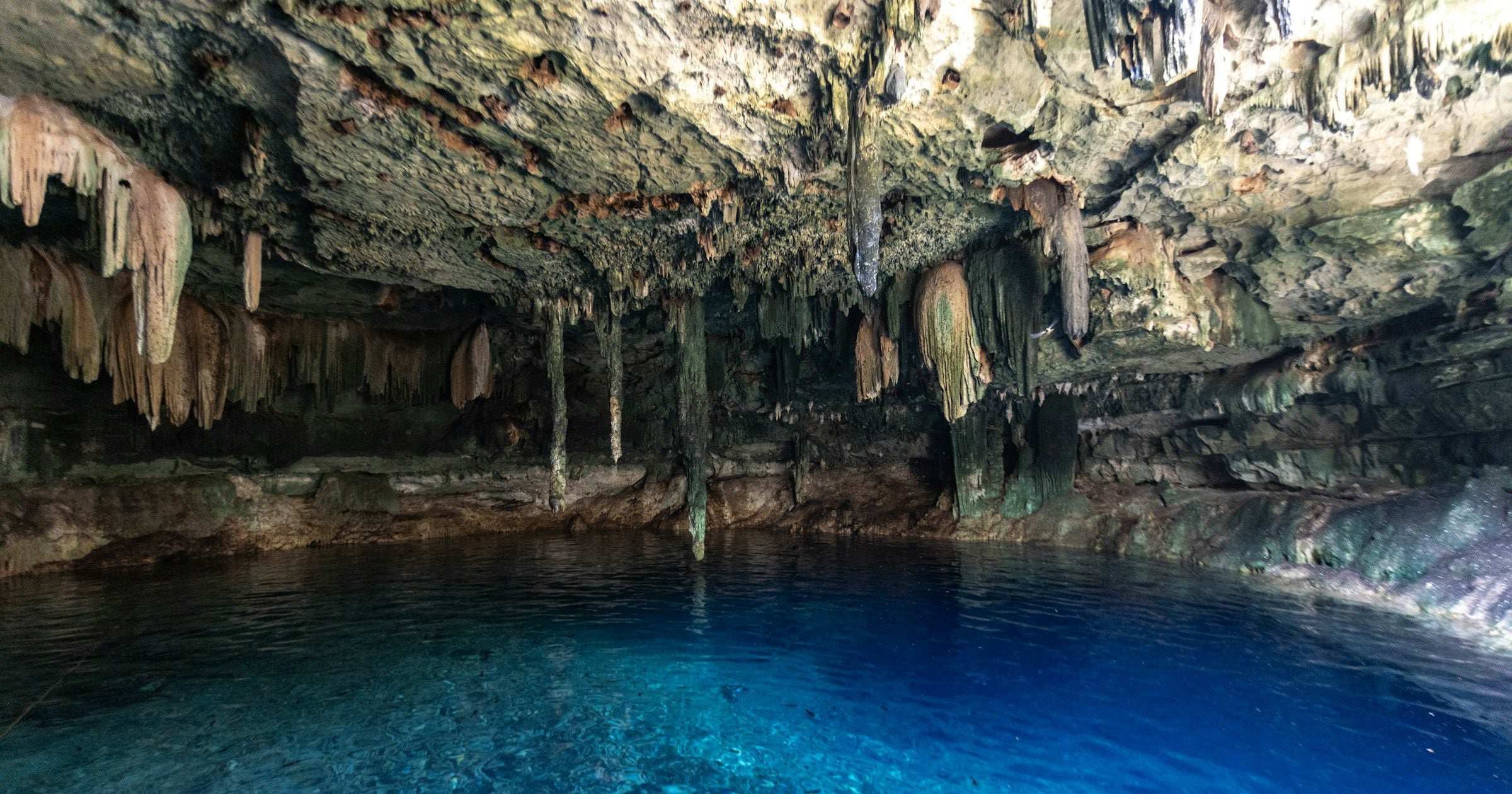Yucatan cenote with stalactite formations and turquoise water in Mexico — a distinctive Mexico travel destination for visitors using an eSIM.