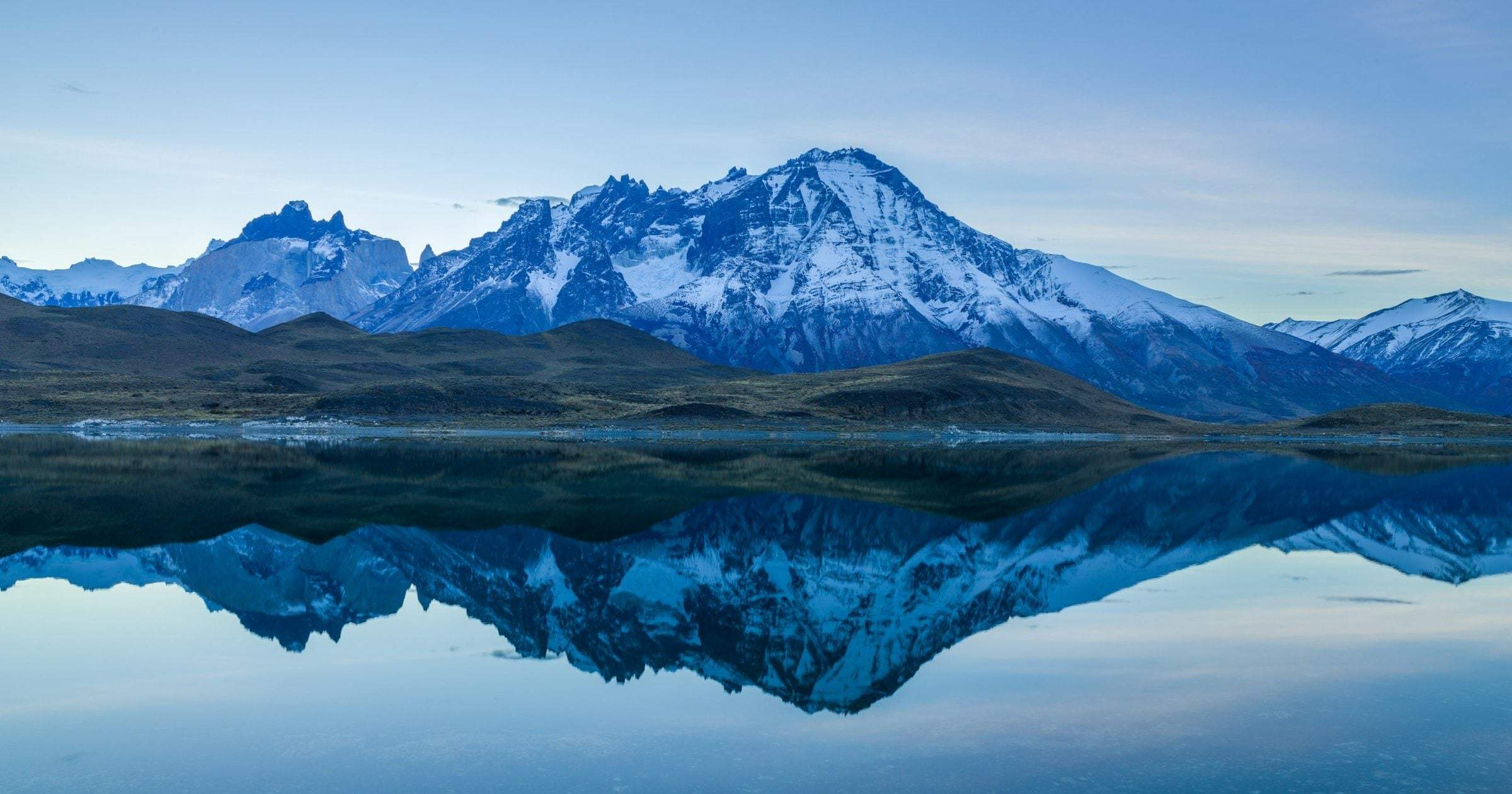 Snow-capped peaks of the Torres del Paine reflected in a glacial lake in Chilean Patagonia — a quick guide to eSIM coverage across South America in 2026.