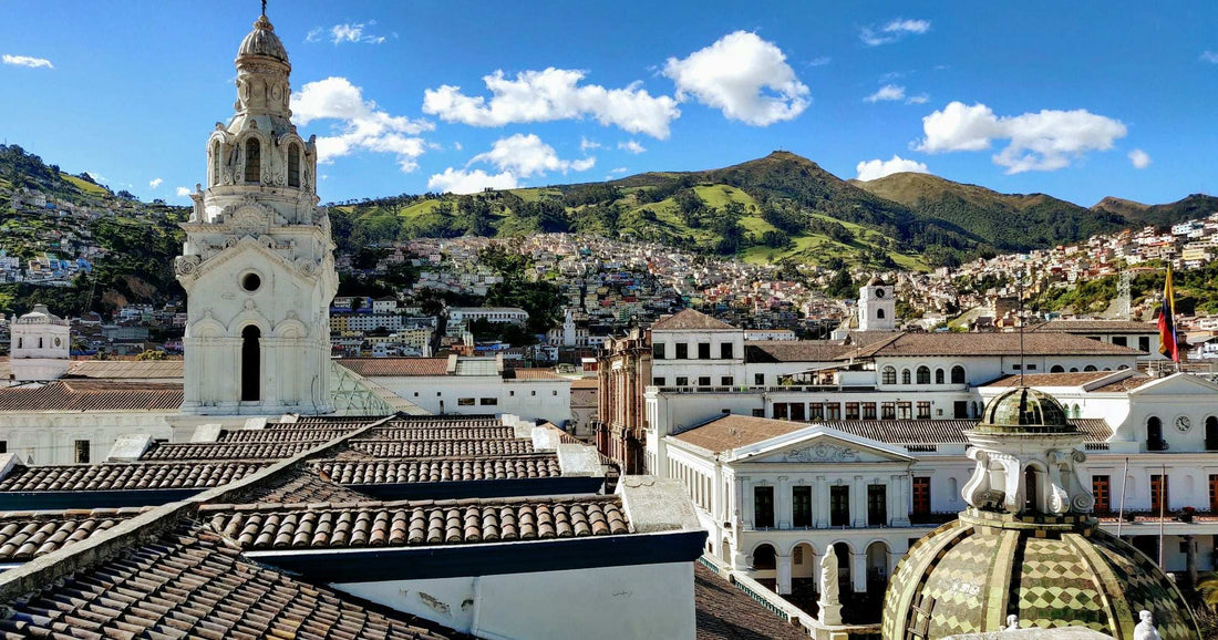 Quito old-town rooftops, church bell tower and Andean foothills in Ecuador — comparing eSIM vs physical SIM for South America travel.