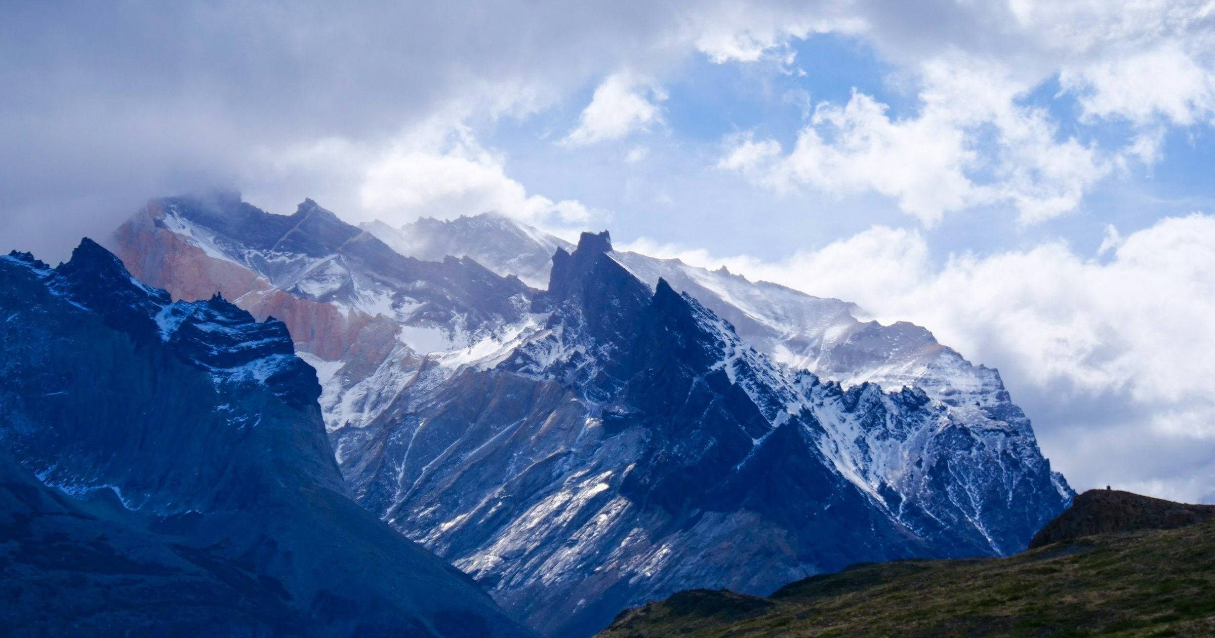 Snow-capped peaks and dramatic clouds at Torres del Paine in Chilean Patagonia — full USD breakdown of what a 2026 Patagonia trip costs.
