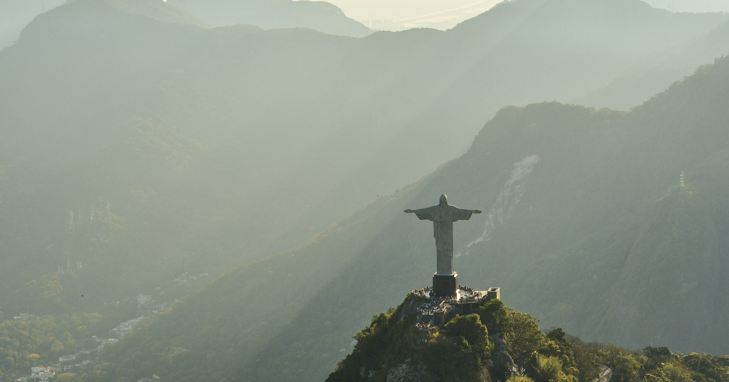 Christ the Redeemer statue at golden hour with the mountains of Rio de Janeiro in the background — Brazil's iconic landmark for travellers setting up an eSIM on iPhone.