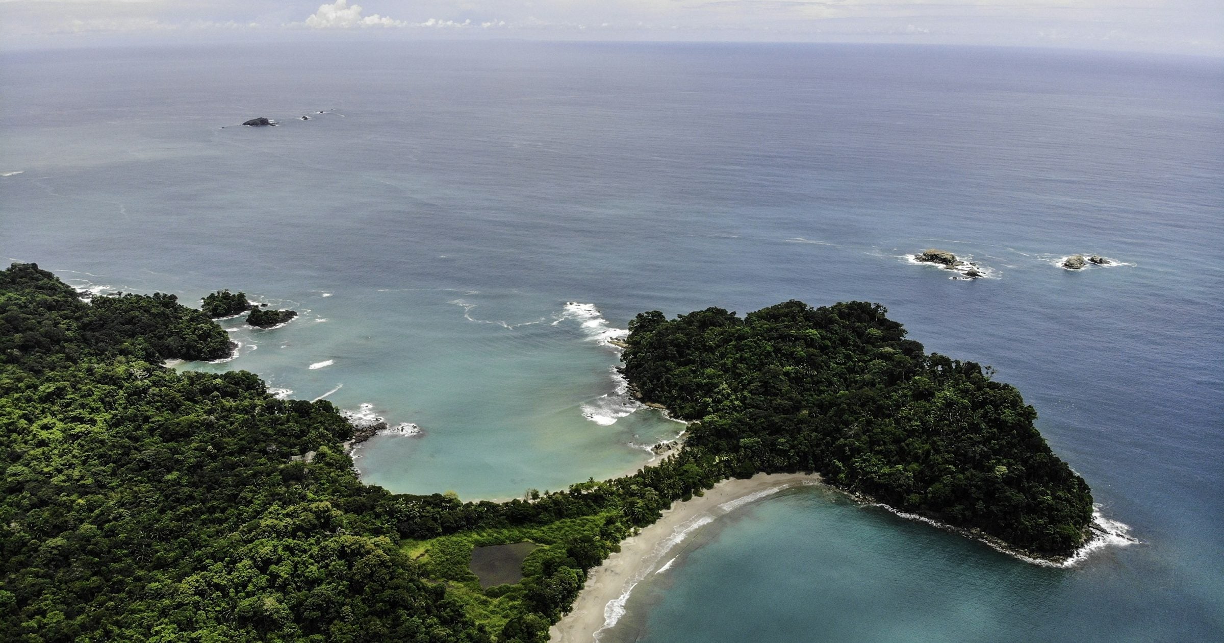 Aerial view of Manuel Antonio National Park's rainforest and Pacific coastline — Costa Rica remains one of Central America's safest travel destinations in 2026.