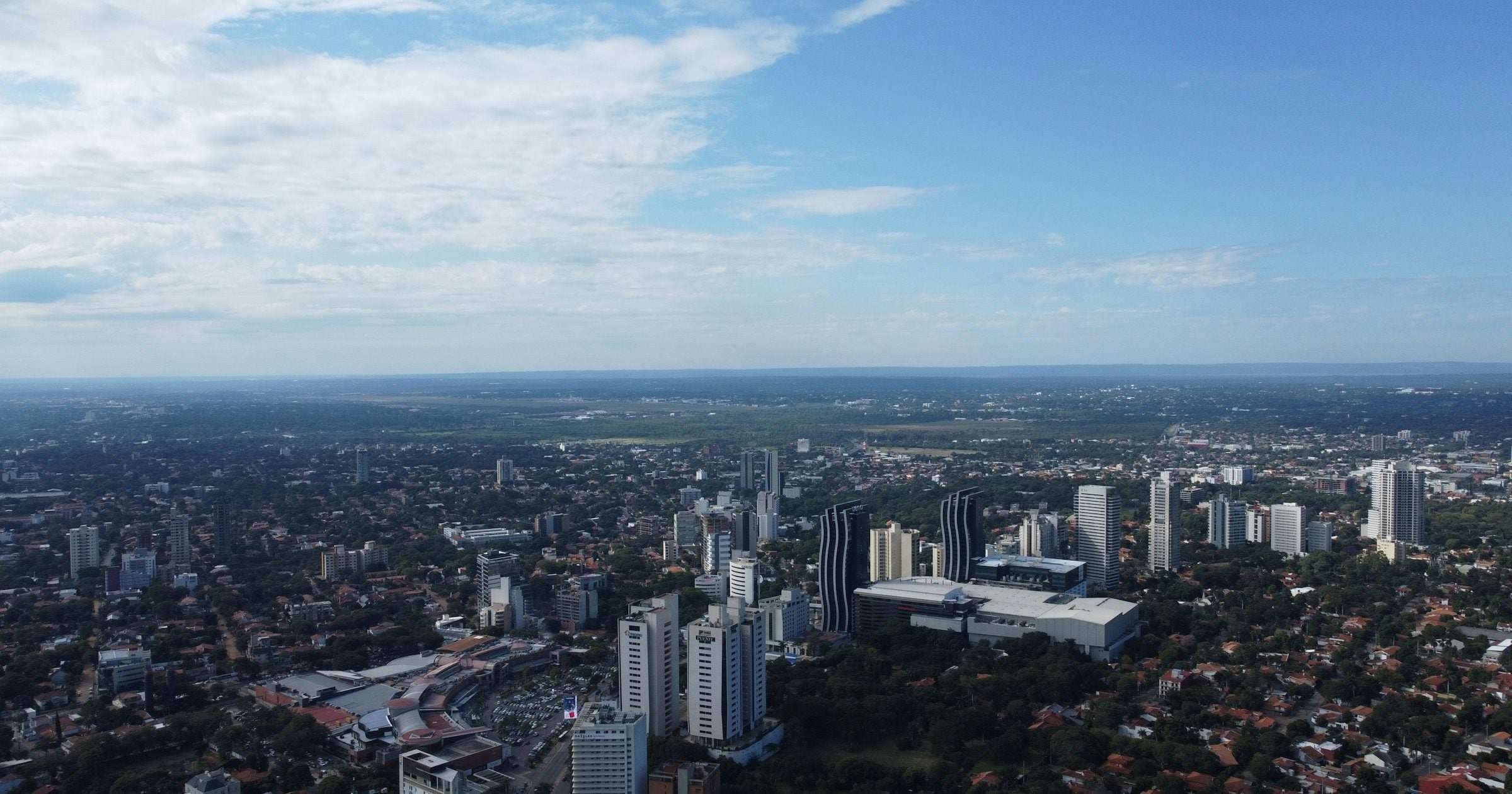 Aerial view of downtown Asuncion, Paraguay under blue sky — capital city skyline for Latam Travellers safety guide