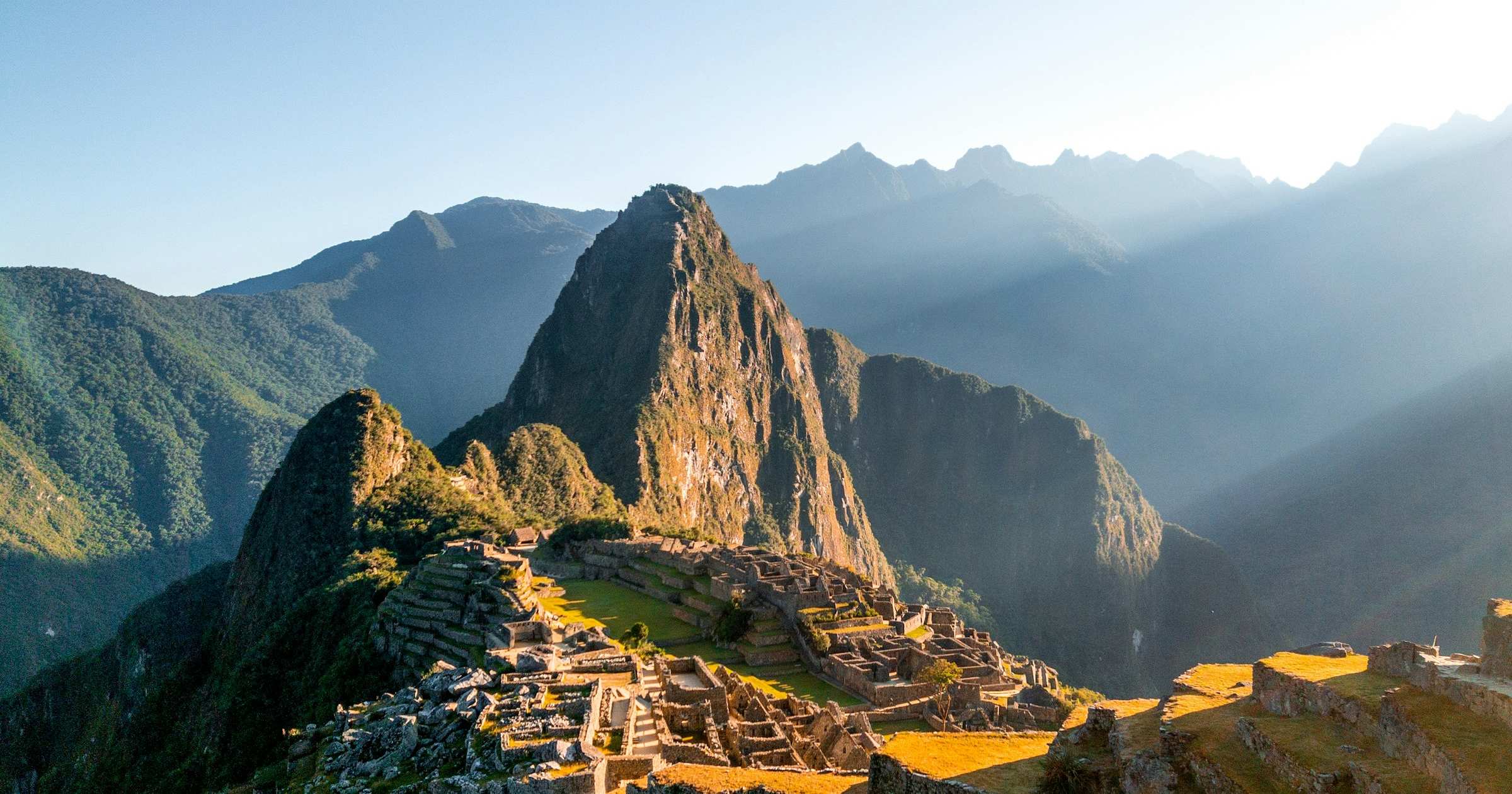 Machu Picchu ancient citadel at sunrise with Huayna Picchu peak in the background, Peru