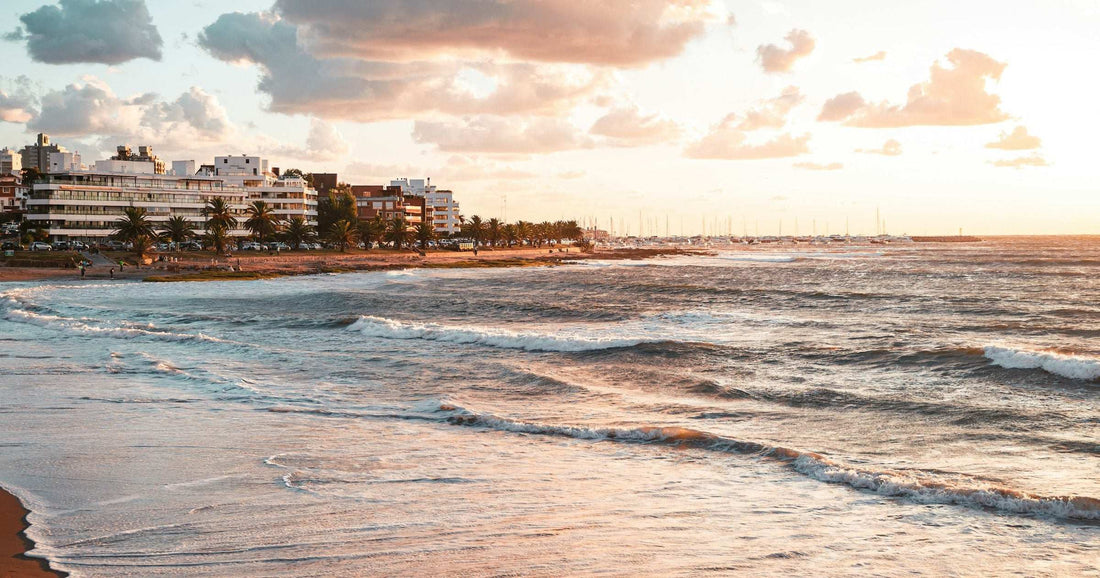 Golden-hour waves on a Punta del Este beach with the Uruguayan coastline behind — a relaxed safe tourist destination