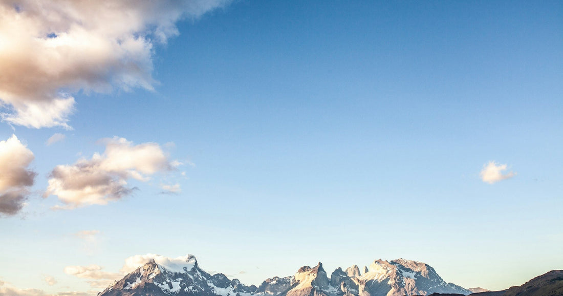 Torres del Paine towers and snow-capped Patagonia peaks at golden hour across the steppe, Argentina and Chile