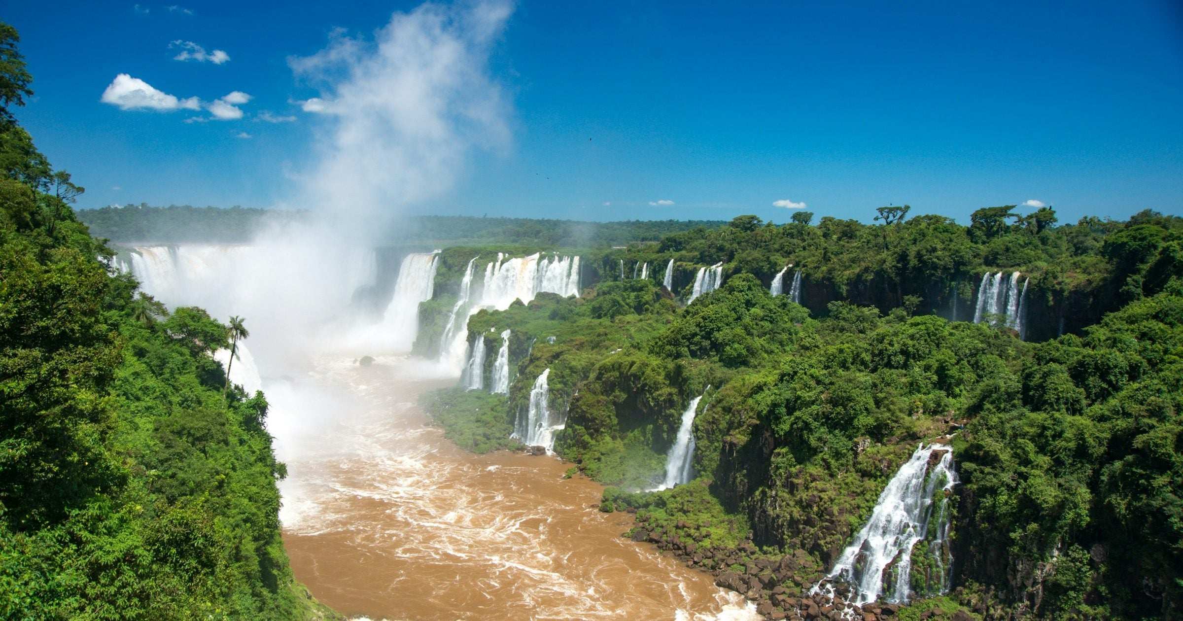 Iguazu Falls cascading between Brazil and Argentina — the iconic border landmark on most multi-country South America itineraries.