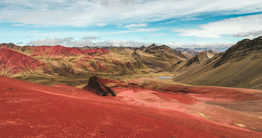 Vinicunca Rainbow Mountain in the Peruvian Andes under a clear August sky — the dry-season Andean weather that defines August in South America, ideal for high-altitude trekking.