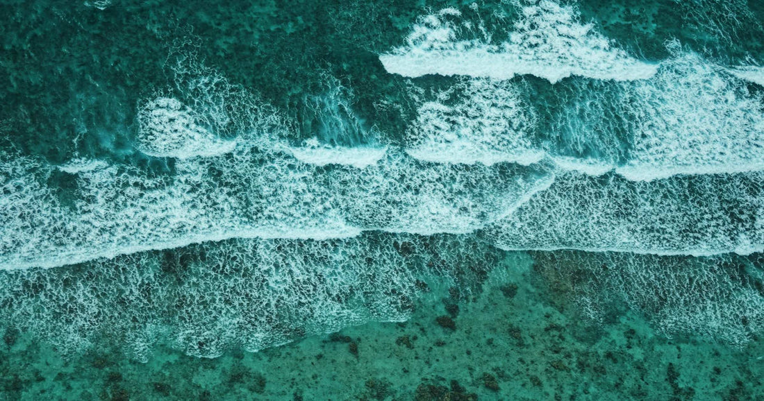 Turquoise waves breaking over the Belize barrier reef seen from above