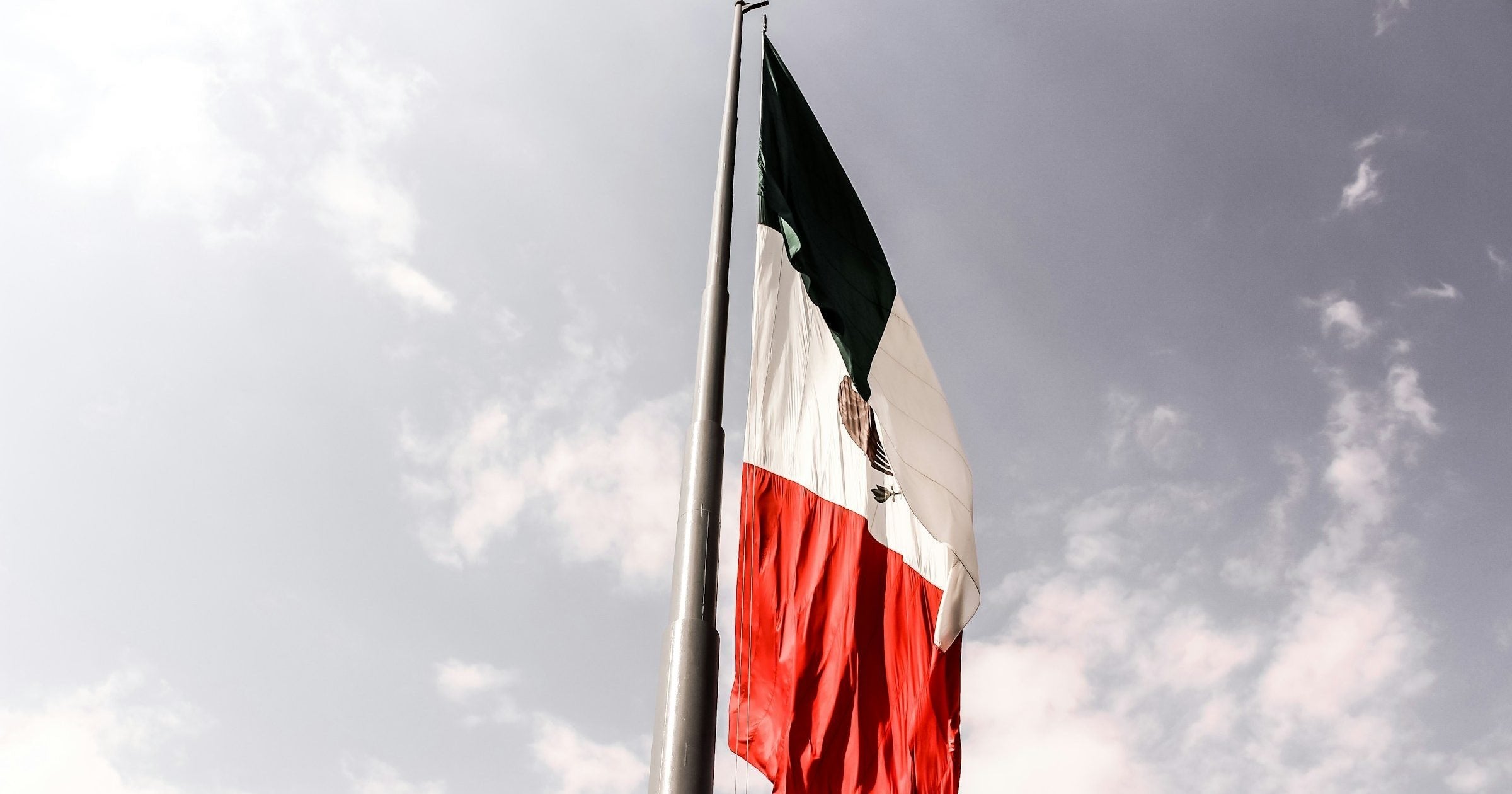 Palacio Nacional in Mexico City Zócalo with the Mexican flag flying against a blue sky